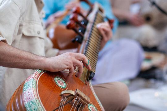 a man plays the sitar at a concert