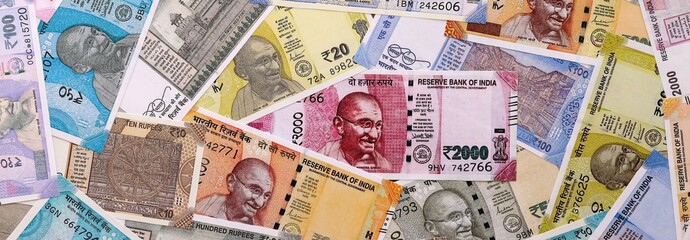 Indian rupee money bills pile on table. India banknotes of INR currency close up.