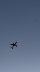 Fototapeta premium Commercial airplane flying in clear blue sky