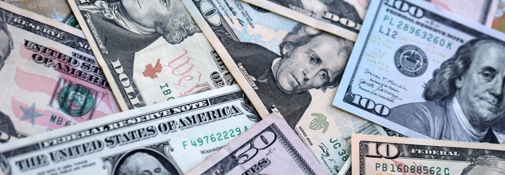 Big pile of US dollar bills in various nominations. United States money banknotes