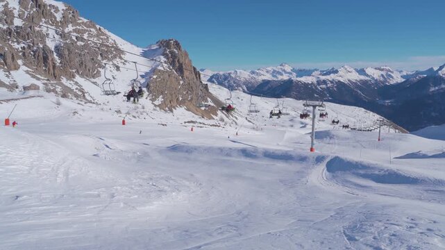 Chairlift And Ski Slopes In Serre Chevalier With Mountain Peaks And Blue Sky, French Alps, Winter Tourism Landscape