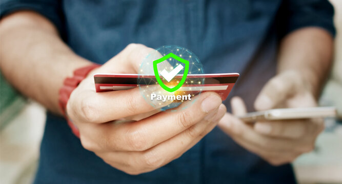 Online security payment concept. Man use smart phone and holding credit card with shopping online.