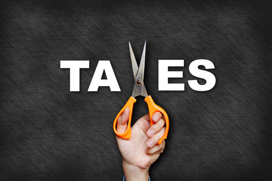 The man's hand holding scissors forms the letter x, creating the word "taxes".
