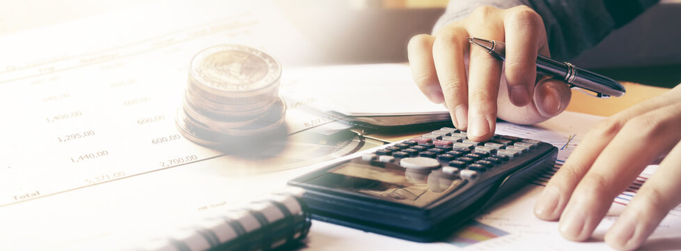 Man using calculator and calculating budgeting and tax calculation monthly expenses.