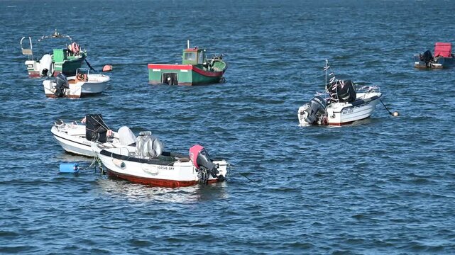 Small boats floating on Tagus River near Lisbon