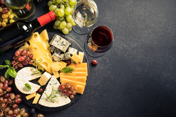 Cheese platter and red wine on black background.