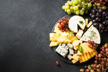Cheese platter with craft cheese assortment on slate board.