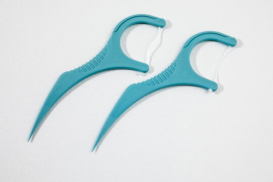 Two Dental Floss Picks Isolated On White Background Closeup