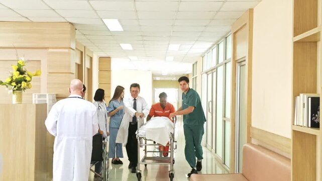Medical team rushing a patient on a gurney through a bright hospital corridor, with doctors and nurses in scrubs coordinating urgent care.