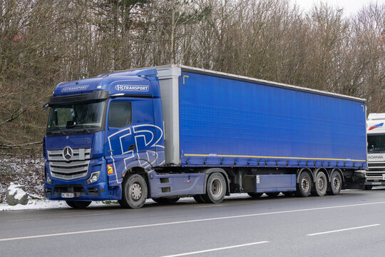Nancy, France - January 6th 2026 : View on a blue truck Mercedes-Benz Actros L 1948 with a blue trailer parked on a street with trees in the background.