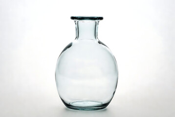 Vase clear glass with round body and narrow neck, transparent, elegant, minimalist, modern, decorative, empty, isolated, white background featuring tableware, home decor, interior design with