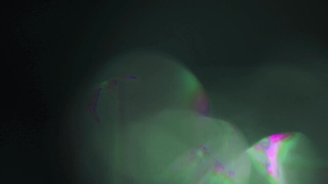 Light leak and bokeh overlay with swirling green and pink light effects. Perfect for adding a dreamy, ethereal feel to your video projects.