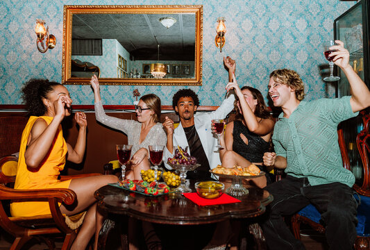 Happy friends enjoying a party night out at a bar