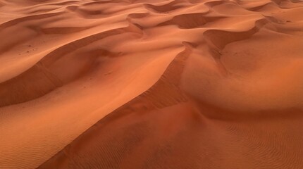 Vibrant desert sand dunes with wavy textures and warm orange hues