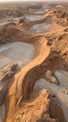 Aerial view of arid desert landscape with dry lake beds and sand dunes