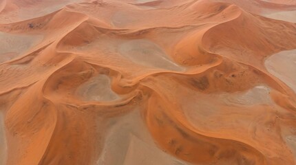 Stunning aerial view of vibrant orange sand dunes in desert landscape