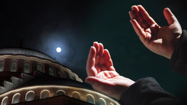 Dome of Camlica Mosque with full moon and praying hands. Ramadan or islamic concept video.