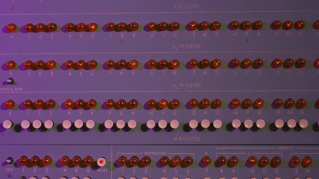 Colorful buttons and levers on control panel in control room