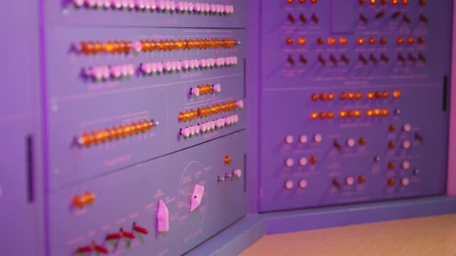 Colorful buttons and levers on control panel in control room