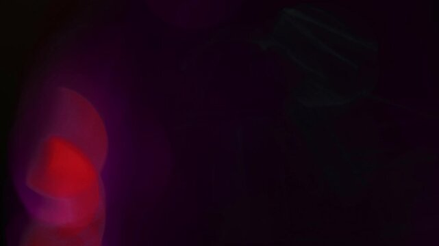 light leak and bokeh overlay with vibrant red and purple hues, creating a dreamy, glowing effect. This clip is perfect for adding atmosphere to videos.