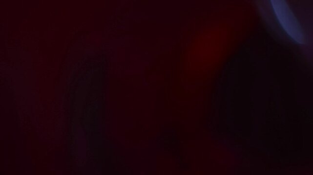 Light leak and bokeh overlay with deep red and purple tones, ideal for adding atmospheric effects or transitions in video projects.