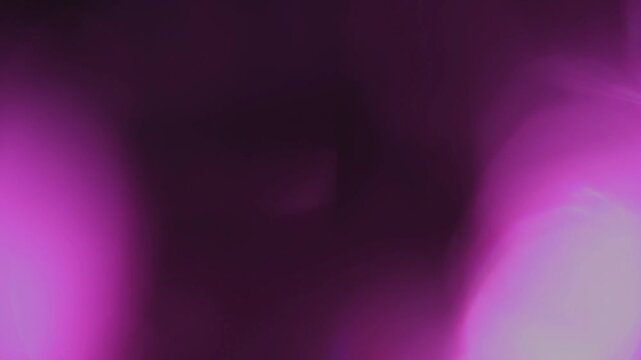Light leak and bokeh overlay with a vibrant magenta and dark purple color palette, creating a dreamy, ethereal atmosphere. This footage is perfect for adding a cinematic feel to your projects.