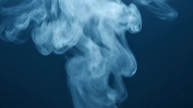 Abstract ethereal white smoke plumes rising and swirling in slow motion against a dark navy blue background cinematic motion graphics