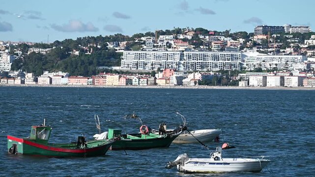 Small fishing boats anchored on Tagus River Trafaria