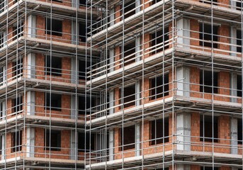 New High-Rise Building under Construction with Scaffolding, Representing Urban Development and Investment Growth