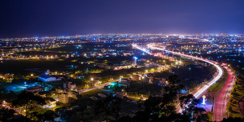 Fototapeta premium Yilan County Night View - City skyline with car light trails at night in Yilan, Taiwan.