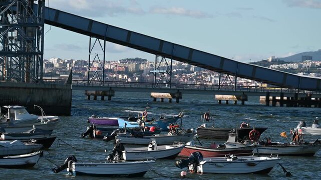 Fishing boats near industrial pier in Trafaria harbor