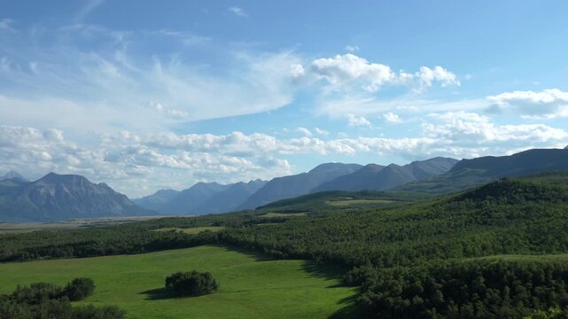 An aerial panorama reveals a serene green landscape with distant mountains, evoking peace and natural beauty