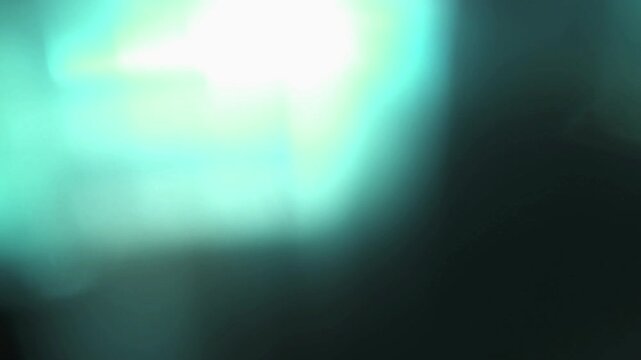light leak and bokeh overlay with glowing teal and white flares. This footage is perfect for adding a cinematic feel and dynamic visual effects to your projects.