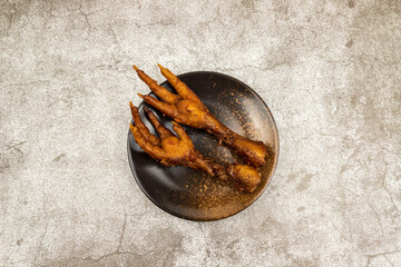 Fototapeta premium The marinated chicken feet in the round dish