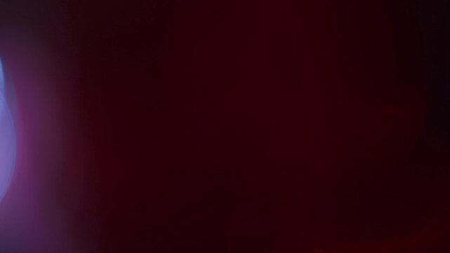Light leak and bokeh overlay with vibrant red and blue hues, creating a dynamic, glowing effect. This visual is perfect for adding atmosphere to videos.