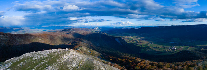 Fototapeta premium Aerial drone view of the autumn landscape surrounding the beech forest and the Sanctuary of San Miguel de Excelsis in the Sierra de Aralar. Huarte-Araquil, Navarre, Spain, Europe