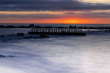 Obraz premium Amazing colourful sunrise seen over the Mediterranean Sea from Barceloneta Beach, which is located next to Barcelona's classic fishing quarter. It is the cities oldest and best-loved beach and gives w