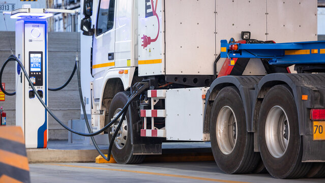 EV charging and semi truck electric vehicle, Electric vehicle semi truck trailer charging station for charge EV battery, Plug for vehicle electric engine, EV charger semi truck trailer station.