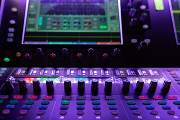 Close-up of Sound Mixer Faders with Neon Purple and Blue Professional Lighting