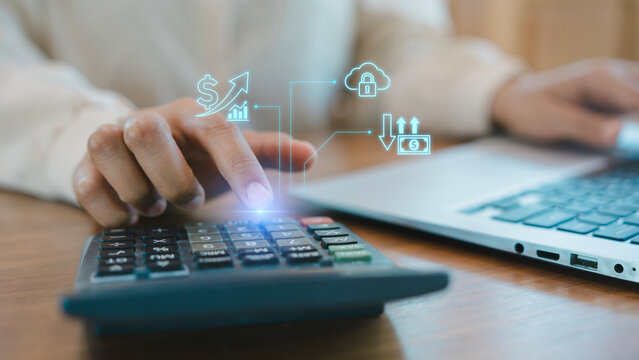 Business person hand using calculator and laptop with virtual cloud security and financial cash flow icons for accounting budget planning concept, Tax preparation, Wealth management