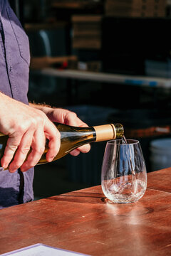 Pouring wine into glass.