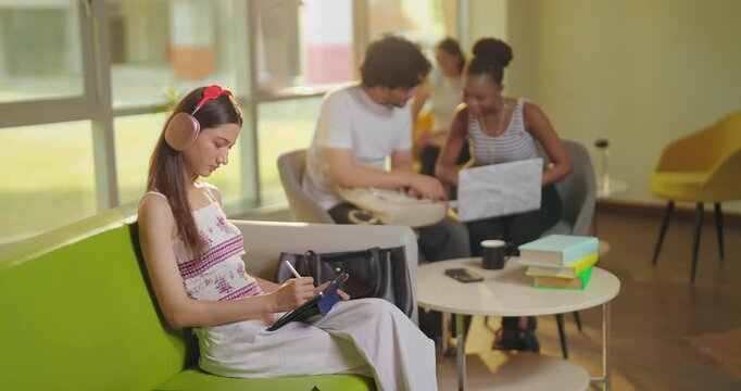 Indian young adult gen z girl use laptop tablet hold look screen do e learning check study work teen age male female man woman talk speak share gossip new plan ideas enjoy day spend time room place