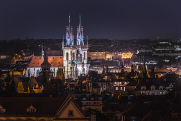 Fototapeta premium Night cityscape of Prague with illuminated Church of Our Lady before Tyn and historic rooftops in Old Town Czech Republic