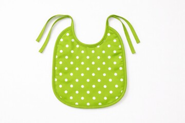 Bright green baby bib with white polka dots and tie straps isolated on white