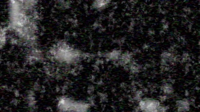 Dynamic video of a dark, grunge texture with shimmering abstract light particles and digital static, perfect for modern and futuristic visuals.