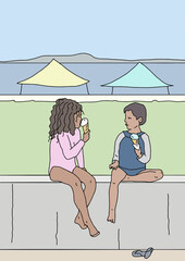 Young children sitting on wall eating ice cream in cones near the beach