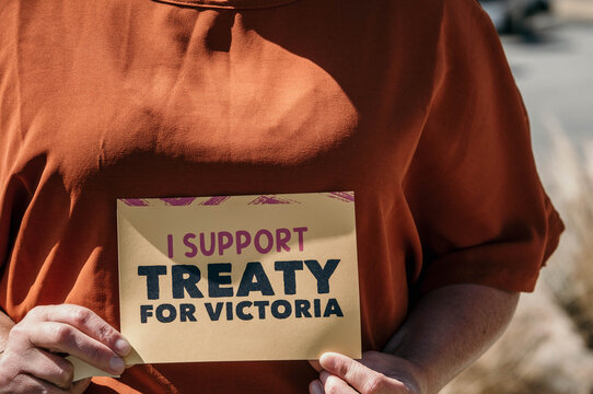 Hands holding treaty sticker