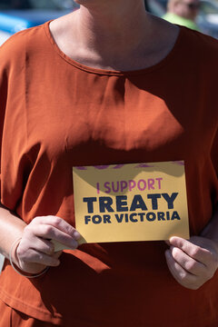 Hands holding treaty sticker.
