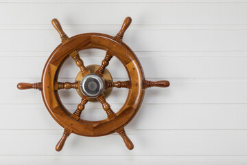 Wooden vintage ship's steering wheel with copy space