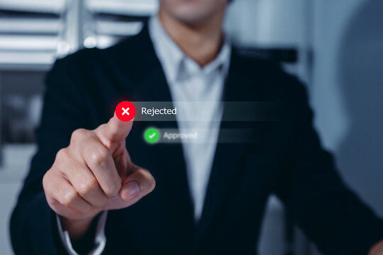 Businessman pressing virtual Rejected button with check mark on digital interface, decision denial. online banking, loan application, Disapproved, and secure Concept.